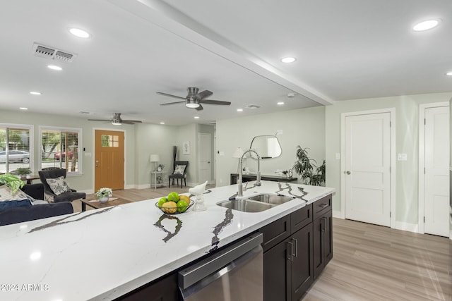 kitchen featuring dishwasher, light hardwood / wood-style floors, sink, ceiling fan, and light stone counters