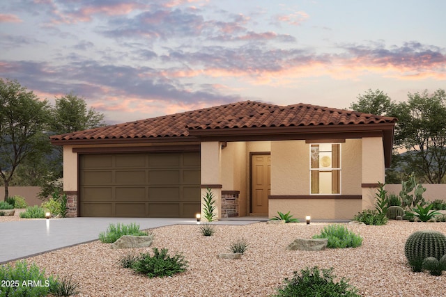 mediterranean / spanish-style house featuring driveway, an attached garage, and stucco siding