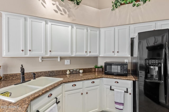 kitchen with white cabinetry and black appliances