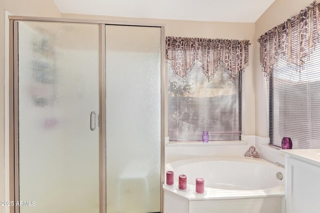 bathroom featuring vanity and plus walk in shower