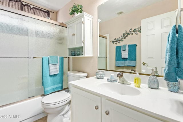 full bathroom with vanity, combined bath / shower with glass door, and toilet