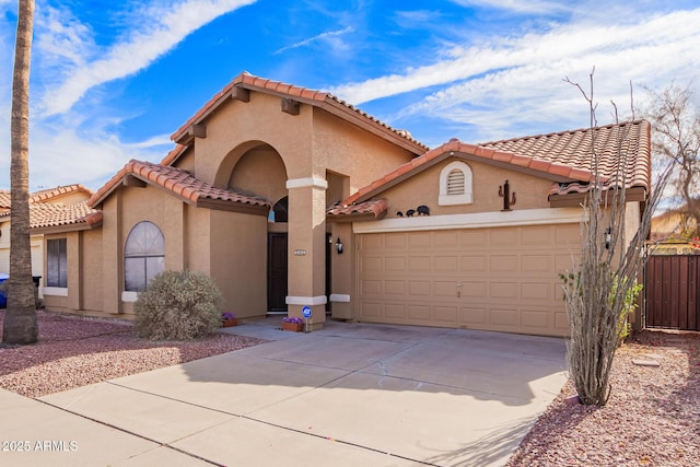 mediterranean / spanish-style home with a garage