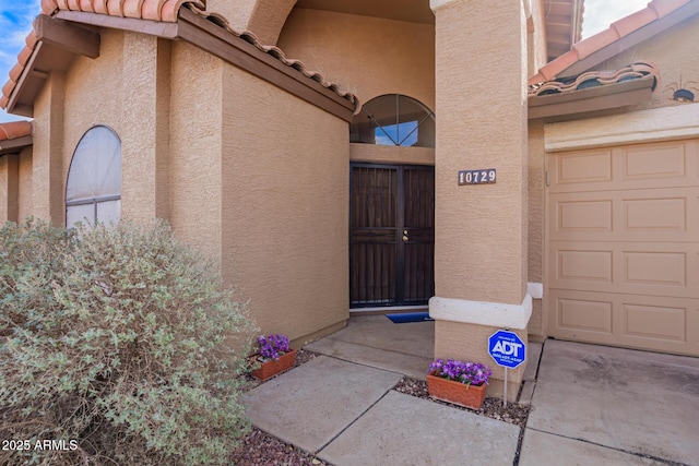 view of exterior entry featuring a garage