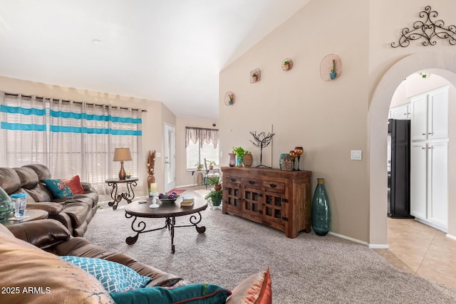 tiled living room with high vaulted ceiling