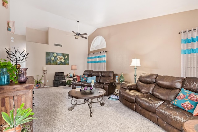 living room featuring lofted ceiling, ceiling fan, and carpet flooring