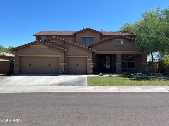 craftsman house with a front yard and a garage