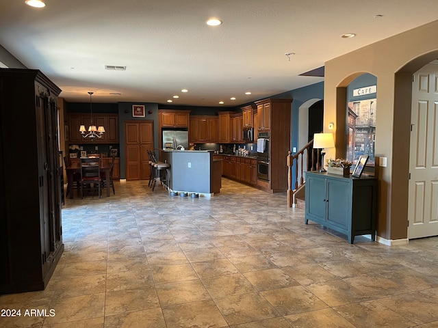 kitchen with a kitchen island, a kitchen breakfast bar, decorative light fixtures, an inviting chandelier, and stainless steel refrigerator with ice dispenser