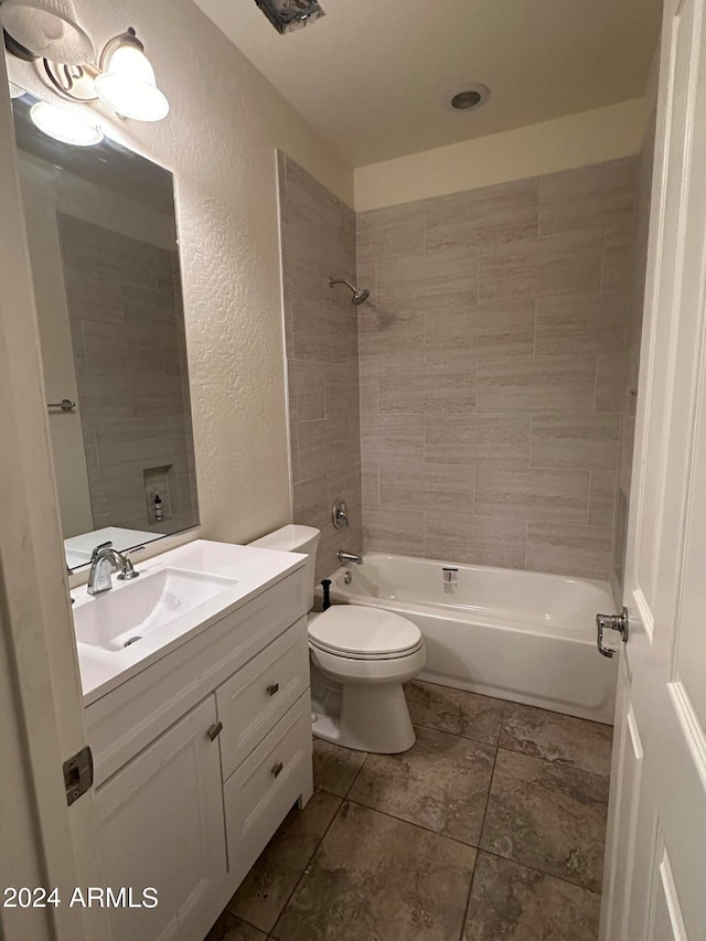 full bathroom featuring toilet, tiled shower / bath combo, and vanity