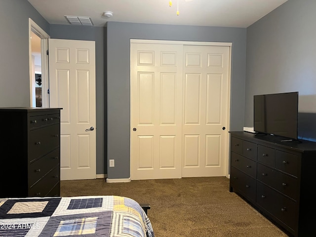 bedroom featuring dark carpet and a closet