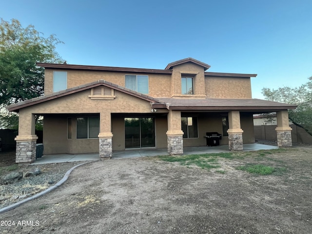 back of property with a patio