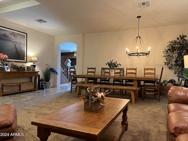 carpeted living room featuring a chandelier