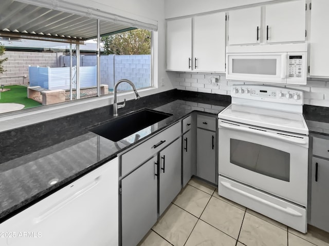 kitchen featuring sink, white appliances, gray cabinets, light tile patterned floors, and white cabinets