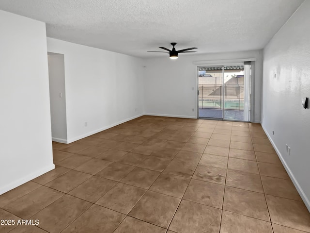 unfurnished room featuring a textured ceiling, tile patterned floors, and ceiling fan