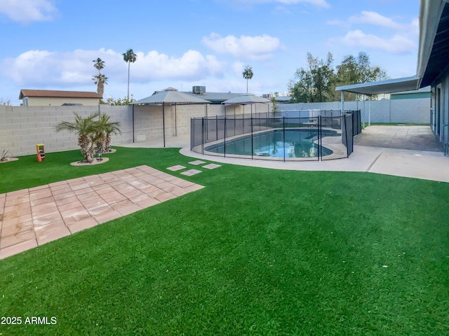 view of yard featuring a fenced in pool and a patio