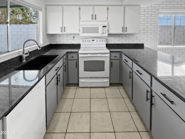 kitchen featuring white cabinetry, sink, gray cabinetry, and white appliances