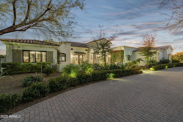 mediterranean / spanish-style house with a tile roof and stucco siding