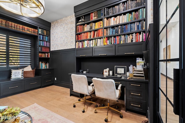 office area featuring light wood-type flooring, a wainscoted wall, and wallpapered walls