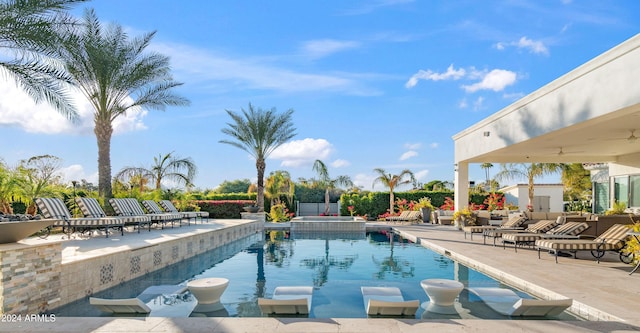 view of swimming pool with a pool with connected hot tub and a patio