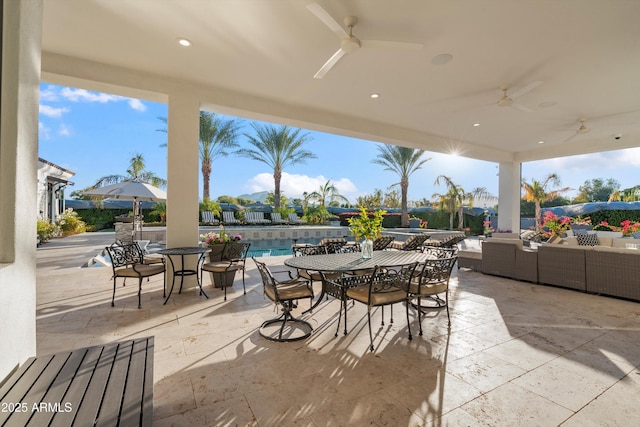 view of patio featuring a ceiling fan, outdoor dining space, and an outdoor pool