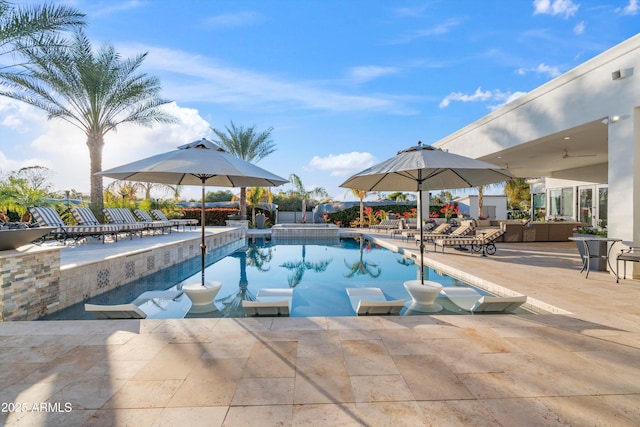 pool featuring an outdoor hangout area and a patio area