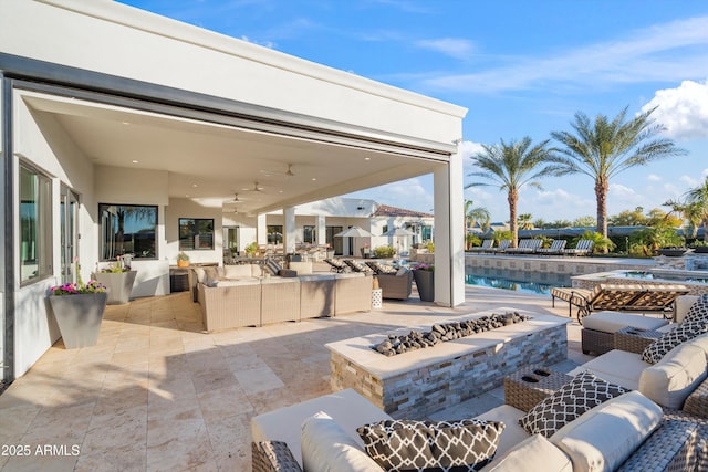 view of patio featuring an outdoor living space with a fire pit and an outdoor pool