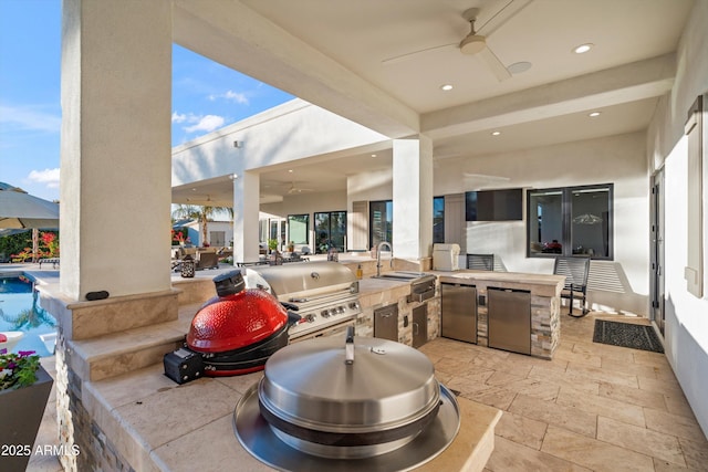 view of patio with a ceiling fan, a pool, a sink, and area for grilling