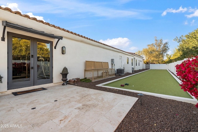 view of patio / terrace featuring french doors, a fenced backyard, and central air condition unit