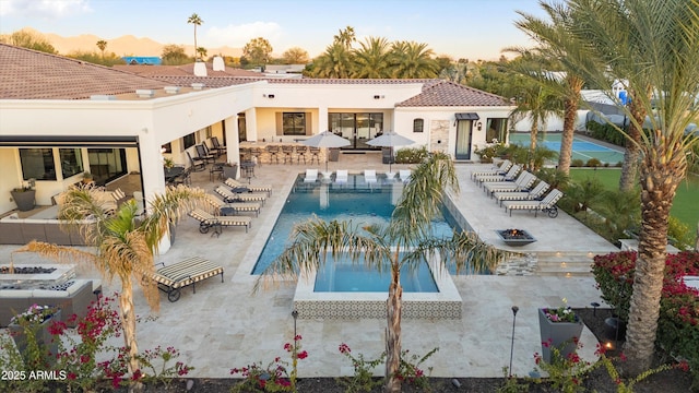 pool featuring a patio and a hot tub