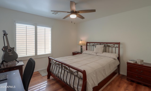 bedroom with ceiling fan and dark hardwood / wood-style flooring