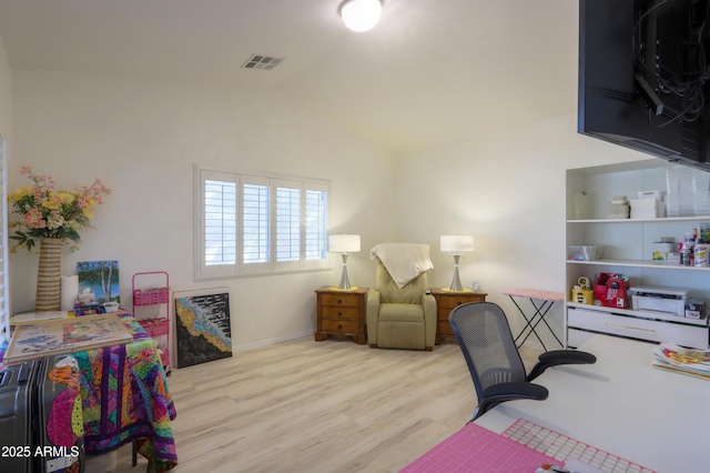 home office with lofted ceiling and light wood-type flooring