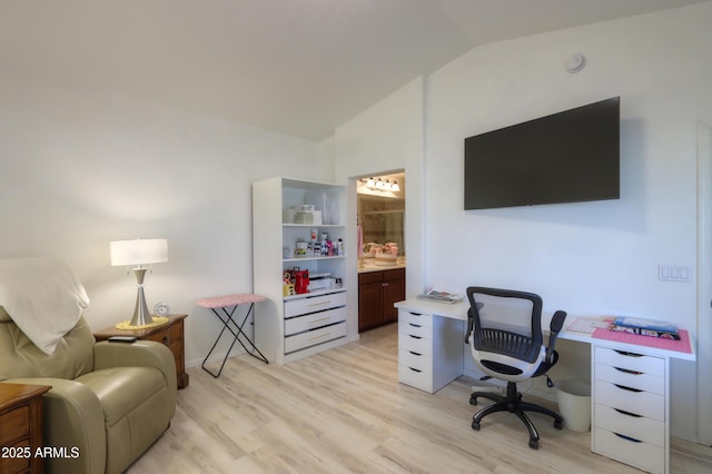 home office featuring vaulted ceiling and light hardwood / wood-style floors