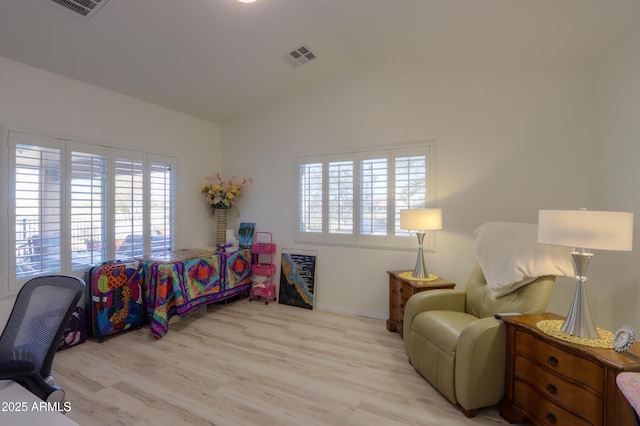 bedroom featuring lofted ceiling and light hardwood / wood-style flooring