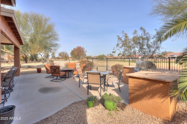 view of patio featuring an outdoor fire pit and exterior kitchen