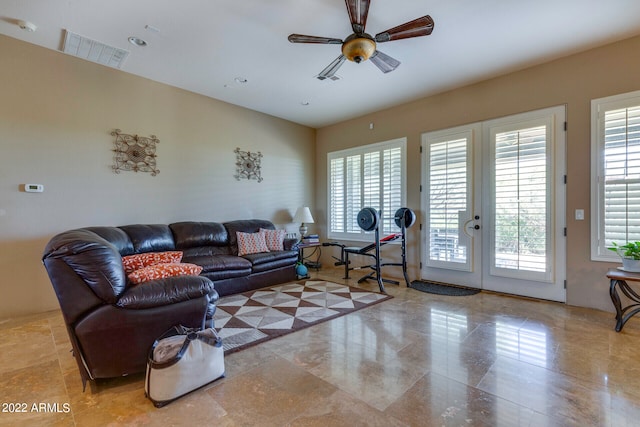 living room featuring light tile flooring, ceiling fan, a wealth of natural light, and french doors