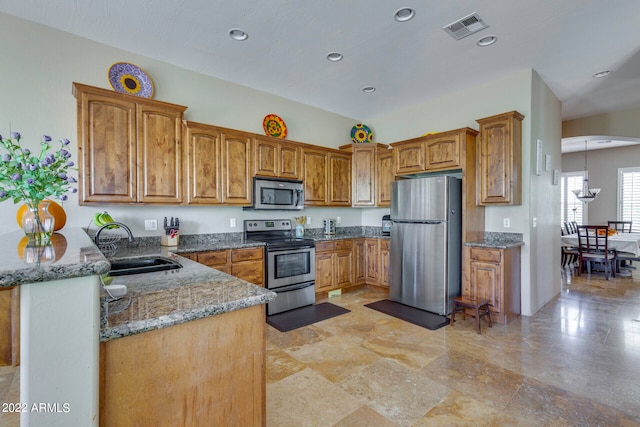 kitchen featuring sink, dark stone counters, stainless steel appliances, and light tile floors