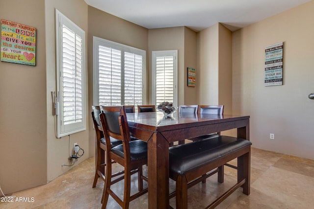 dining space featuring a wealth of natural light and light tile floors