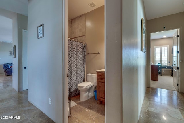 bathroom featuring toilet, tile floors, and vanity