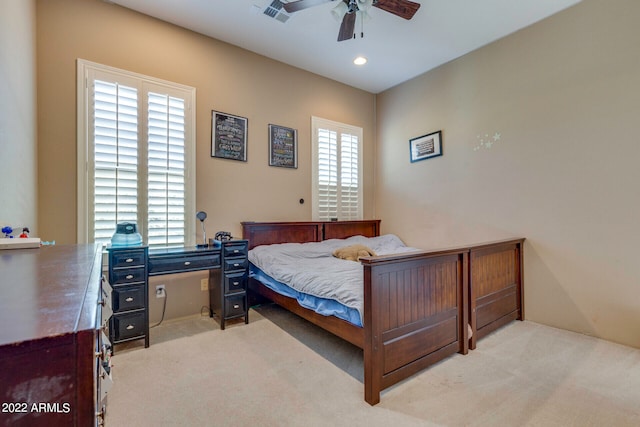 bedroom featuring ceiling fan and light carpet