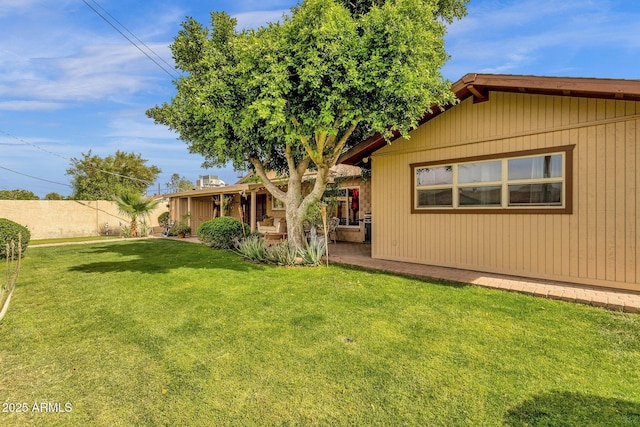 back of property with fence and a yard