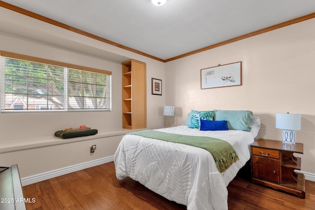 bedroom featuring baseboards, ornamental molding, and wood finished floors