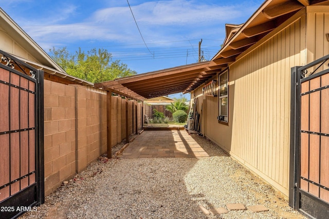 view of side of property with a patio and fence