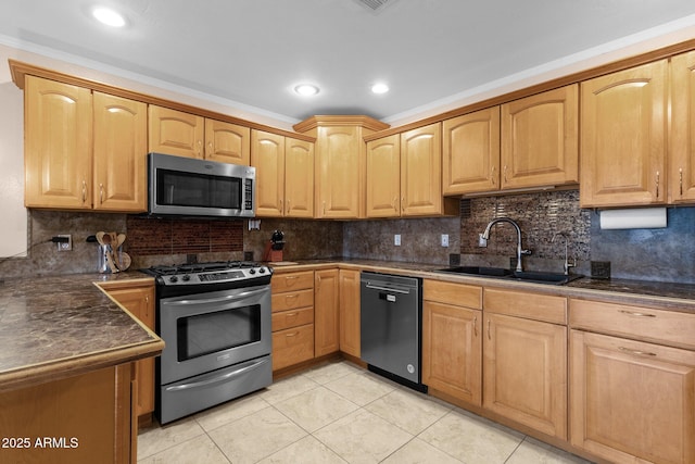kitchen featuring a sink, appliances with stainless steel finishes, light tile patterned floors, and decorative backsplash