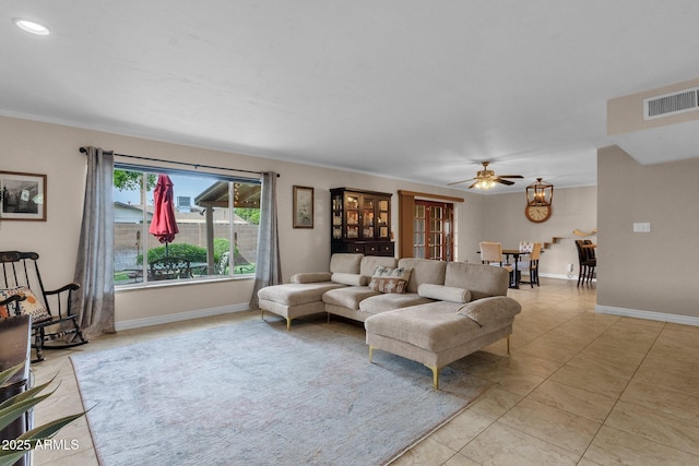 living room with baseboards, ceiling fan, light tile patterned flooring, and visible vents