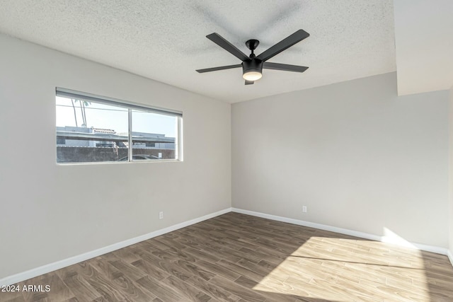 spare room featuring hardwood / wood-style floors, ceiling fan, and a textured ceiling