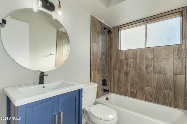 full bathroom featuring vanity, tiled shower / bath combo, and toilet