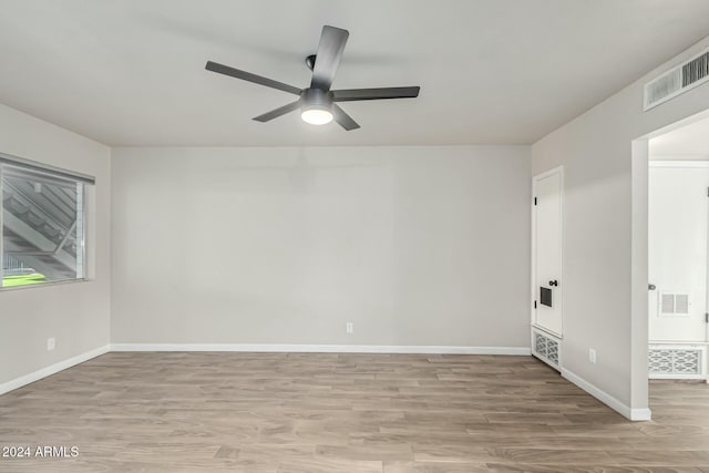 empty room featuring ceiling fan and light hardwood / wood-style flooring