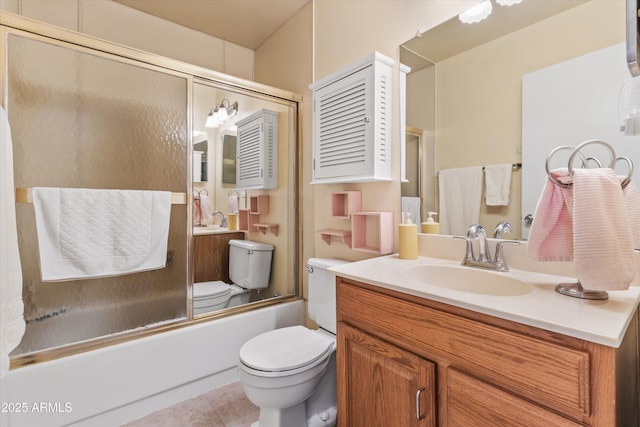 full bathroom with tile patterned flooring, vanity, toilet, and combined bath / shower with glass door