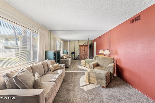 living room with carpet flooring and a textured ceiling