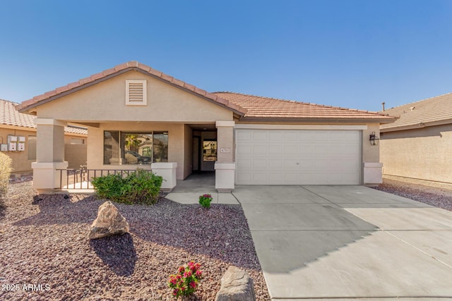 ranch-style house featuring a garage, concrete driveway, a tiled roof, and stucco siding