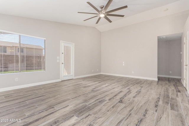 unfurnished room with lofted ceiling, light wood finished floors, baseboards, and a ceiling fan